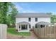 Exterior home view featuring a fenced backyard, lawn, and covered patio, perfect for outdoor living at 2517 Marlowe Ave, Charlotte, NC 28208