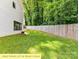 Wide private backyard lot features a lush lawn, tall trees, and a wooden privacy fence at 2517 Marlowe Ave, Charlotte, NC 28208