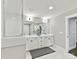 Bathroom features double vanity with white cabinets, large mirrors, and a glass door shower at 2517 Marlowe Ave, Charlotte, NC 28208