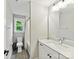 Bright bathroom features large sink vanity with tile floors, and natural light from the window at 2517 Marlowe Ave, Charlotte, NC 28208