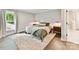 Comfortable bedroom features a large window and plush rug on hardwood floors at 2517 Marlowe Ave, Charlotte, NC 28208