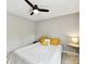 Cozy bedroom with neutral gray walls, bright ceiling fan, and a comfortable bed at 2517 Marlowe Ave, Charlotte, NC 28208