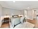 Relaxing bedroom with soft lighting, hardwood flooring, and a comfortable bed with plush rug at 2517 Marlowe Ave, Charlotte, NC 28208