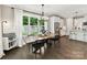 Bright dining room with modern lighting, large windows overlooking backyard, and hardwood floors at 2517 Marlowe Ave, Charlotte, NC 28208