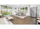 Bright dining room area featuring lots of natural light, seating for six, and stainless steel refrigerator at 2517 Marlowe Ave, Charlotte, NC 28208