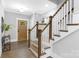 Inviting entryway showcases hardwood floors, a modern staircase with wood railings, and a stylish front door at 2517 Marlowe Ave, Charlotte, NC 28208