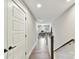 Upstairs hallway with wood floors leads to a bedroom, bathroom, and office at 2517 Marlowe Ave, Charlotte, NC 28208