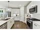 Bright kitchen features white cabinets, stainless steel appliances, and a center island with seating at 2517 Marlowe Ave, Charlotte, NC 28208