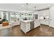 Open kitchen with island and view of the living room and dining area and large sliding glass doors to yard at 2517 Marlowe Ave, Charlotte, NC 28208