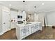 Stylish kitchen featuring white cabinetry, stainless steel appliances, and a large center island with seating at 2517 Marlowe Ave, Charlotte, NC 28208