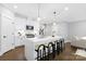 Modern kitchen features a large island, stainless steel appliances, white cabinetry, and a breakfast bar at 2517 Marlowe Ave, Charlotte, NC 28208