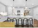 Bright kitchen features white cabinetry, high end quartz waterfall island, and under cabinet lighting at 2517 Marlowe Ave, Charlotte, NC 28208