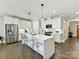 Spacious kitchen with stainless appliances, island with breakfast bar, and white shaker cabinets at 2517 Marlowe Ave, Charlotte, NC 28208