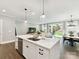 Bright, open concept kitchen with a large island that flows into the living room and dining area at 2517 Marlowe Ave, Charlotte, NC 28208