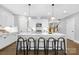 Modern kitchen boasts a large center island with seating, stainless steel appliances, and bright white cabinetry at 2517 Marlowe Ave, Charlotte, NC 28208