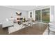 Cozy living room featuring hardwood floors, neutral tones, and sliding door to the outside at 2517 Marlowe Ave, Charlotte, NC 28208