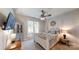 Comfortable bedroom with four poster bed, ceiling fan, and a view to the backyard at 2656 Lee Lawing Rd, Lincolnton, NC 28092