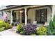 Inviting front porch with beautiful landscaping and craftsman style pillars and warm pendant lighting at 2656 Lee Lawing Rd, Lincolnton, NC 28092