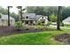 Charming two-story home with landscaped yard, colorful flowers, and inviting covered porch at 2656 Lee Lawing Rd, Lincolnton, NC 28092