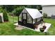 Backyard greenhouse on a concrete pad with several plants at 2656 Lee Lawing Rd, Lincolnton, NC 28092