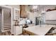 Elegant kitchen with a decorative range hood, island seating, and designer lighting at 2656 Lee Lawing Rd, Lincolnton, NC 28092