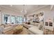 Bright, open living room with a large sectional sofa, statement chandelier, and seamless flow to the kitchen at 2656 Lee Lawing Rd, Lincolnton, NC 28092