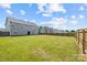 A large backyard features a lush green lawn, a privacy fence, and a view of the house at 2809 Waycross Dr, Monroe, NC 28110