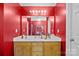 This bathroom features red walls, a large vanity, and a well-lit mirror at 2809 Waycross Dr, Monroe, NC 28110
