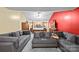 A cozy bedroom with gray sofas, a four-poster bed, wood furniture and warm, colorful walls at 2809 Waycross Dr, Monroe, NC 28110