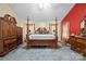 This spacious bedroom features a four poster bed, wood furniture, and warm colorful walls at 2809 Waycross Dr, Monroe, NC 28110