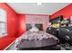 Vibrant bedroom with bold red walls, a black bed frame, and ample storage, offering a cozy personal space at 2809 Waycross Dr, Monroe, NC 28110