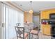 Cozy breakfast nook featuring a glass table, seating for four, and natural light from the sliding door at 2809 Waycross Dr, Monroe, NC 28110