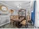 Elegant dining room with a dark wood table and ornate display cabinet, perfect for formal gatherings at 2809 Waycross Dr, Monroe, NC 28110