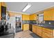 Functional kitchen with wooden cabinets, black appliances, and an adjacent dining area, perfect for everyday meals at 2809 Waycross Dr, Monroe, NC 28110