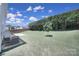 Large backyard with a privacy fence, mature trees and a stone patio at 3015 Liddington Rd, Matthews, NC 28105