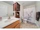 Bathroom with a vanity, cherry cabinets, and a shower with a floral shower curtain at 3015 Liddington Rd, Matthews, NC 28105