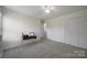 Bedroom featuring a sewing machine desk, fan, and closet, perfect for hobbies at 3015 Liddington Rd, Matthews, NC 28105
