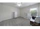 Clean, carpeted bedroom with white furniture, a ceiling fan, and a large window at 3015 Liddington Rd, Matthews, NC 28105