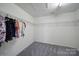 Walk-in closet has wire shelving on two walls and neutral carpet at 3015 Liddington Rd, Matthews, NC 28105