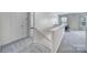 Upstairs hallway with gray carpet and white walls leads to bedrooms and a bonus room at 3015 Liddington Rd, Matthews, NC 28105