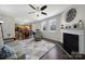 Open-concept living room with a fireplace, hardwood floors, lots of natural light and seamless flow to the kitchen at 3015 Liddington Rd, Matthews, NC 28105