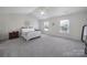 Spacious main bedroom boasts vaulted ceiling, two windows and neutral carpet at 3015 Liddington Rd, Matthews, NC 28105