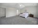 Large primary bedroom with vaulted ceiling and an adjacent ensuite bathroom and closet at 3015 Liddington Rd, Matthews, NC 28105