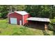 An aerial view reveals the storage building and carport nestled within a lush, green landscape at 3151 Lynn Mountain Rd, Vale, NC 28168