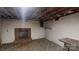 Unfinished basement with brick fireplace, painted walls, and storage shelves at 3151 Lynn Mountain Rd, Vale, NC 28168