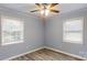 Bedroom featuring two windows, laminate floors, neutral walls, and a ceiling fan at 3151 Lynn Mountain Rd, Vale, NC 28168