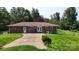 Rear exterior of the home with a brick facade, surrounded by a meticulously maintained lawn at 3151 Lynn Mountain Rd, Vale, NC 28168