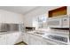Well-appointed kitchen with white cabinets, granite countertops, and modern appliances for a sleek and functional design at 3151 Lynn Mountain Rd, Vale, NC 28168