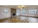 Living room featuring a stone fireplace, ceiling fan, and large windows at 3151 Lynn Mountain Rd, Vale, NC 28168