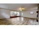 Open living room featuring a stone fireplace and an open floor plan to the kitchen at 3151 Lynn Mountain Rd, Vale, NC 28168